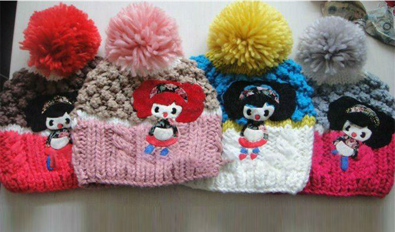 Handmade children's winter warm knitted hat with pompons